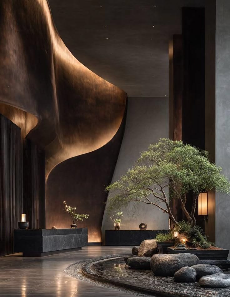 Warm architectural lighting revealing stone, bronze and dark interior finishes