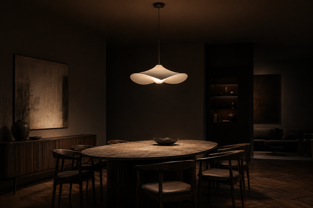Sculptural pendant light illuminating a dark premium interior