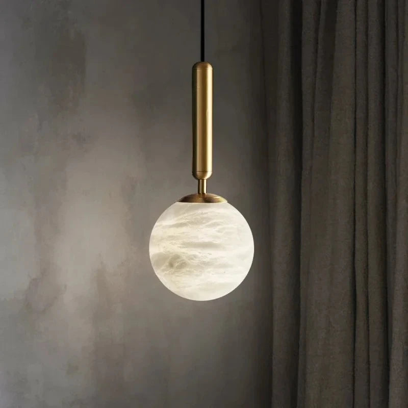 Vela Pillar Natural Marble Chandelier – Luxury styled in a living room interior