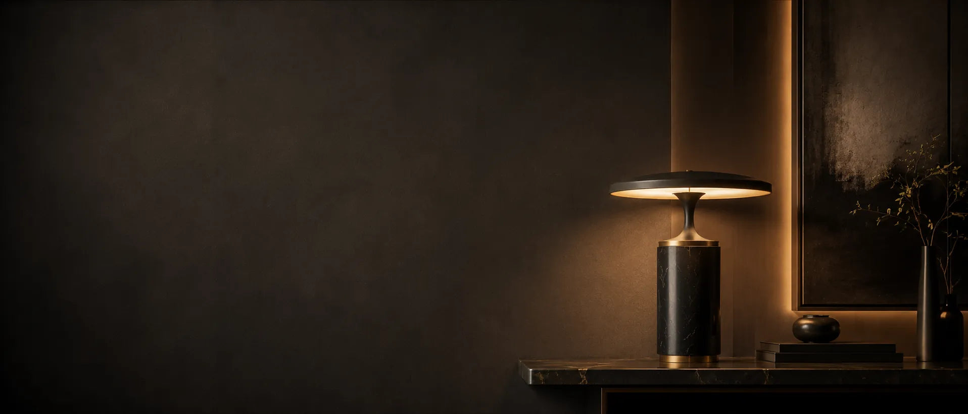 Sculptural table lamp on a dark stone console in a luxury interior