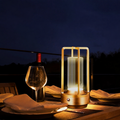 Gold rechargeable cordless table lamp on an evening dining table